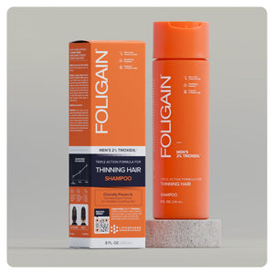 شامبو FOLIGAIN ثلاثي المفعول للرجال بتركيز 2% من TRIOXIDIL، عبوة برتقالية وعلبة.